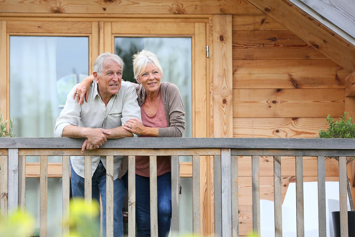 An older couple on their porch outside of their home