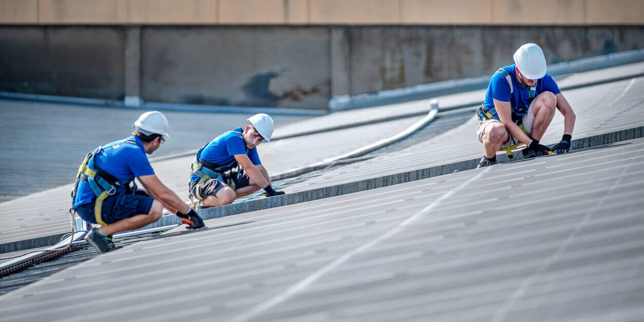 A crew working on a commercial roof