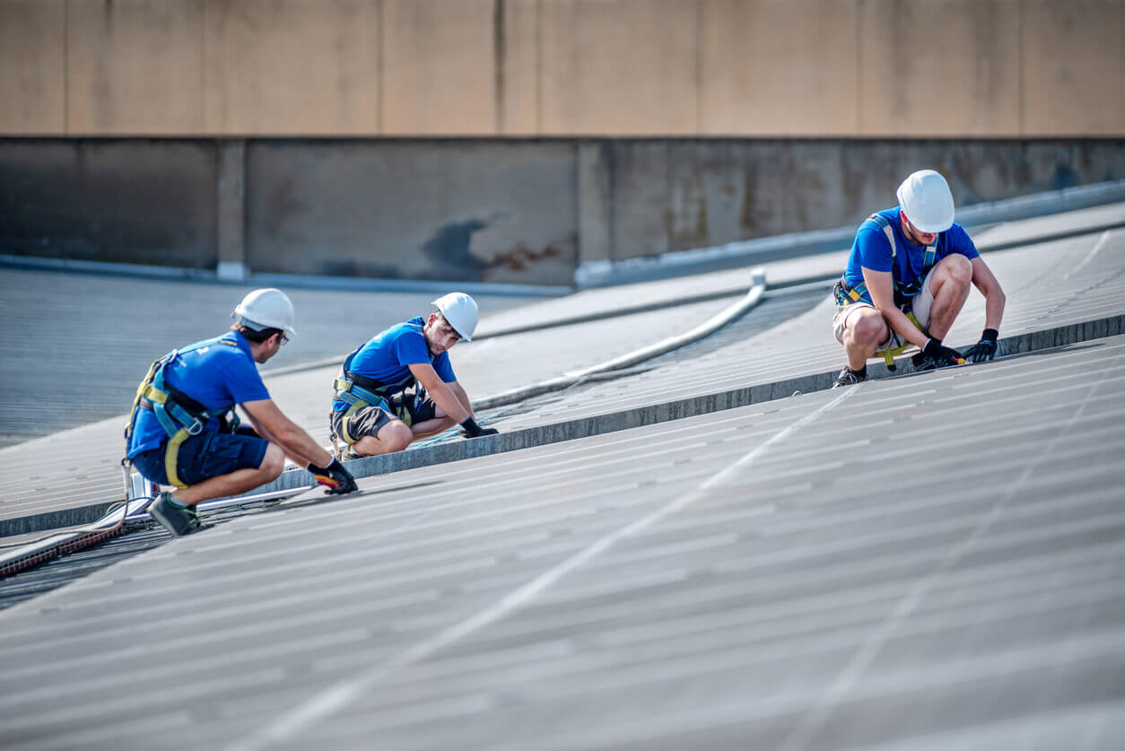 A crew working on a commercial roof