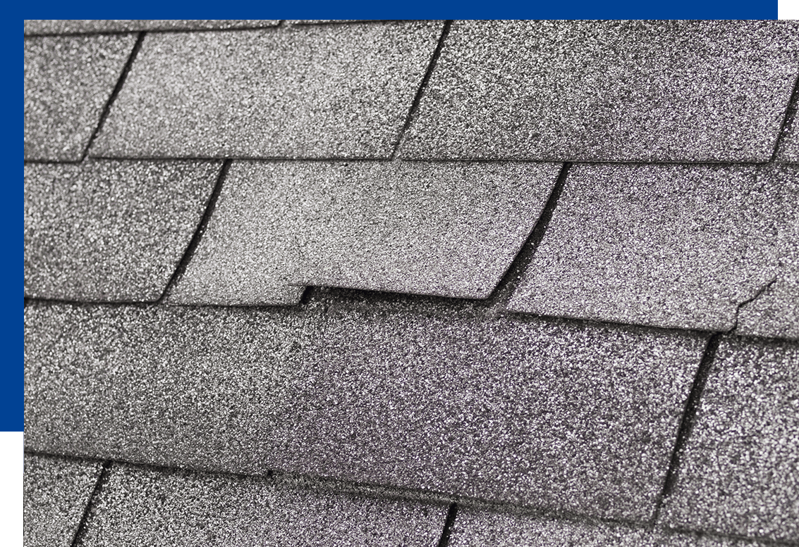 lifted shingles on a roof caused by high winds & storm damage