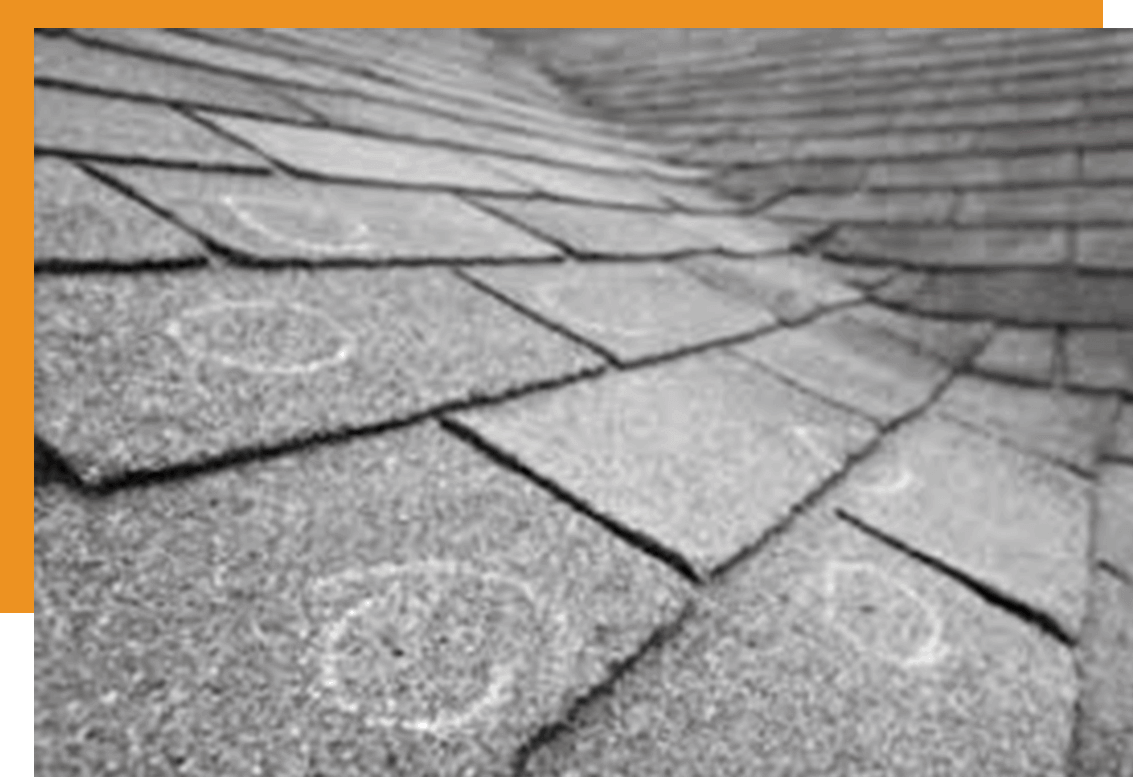 A roof marked where hail damage has occurred