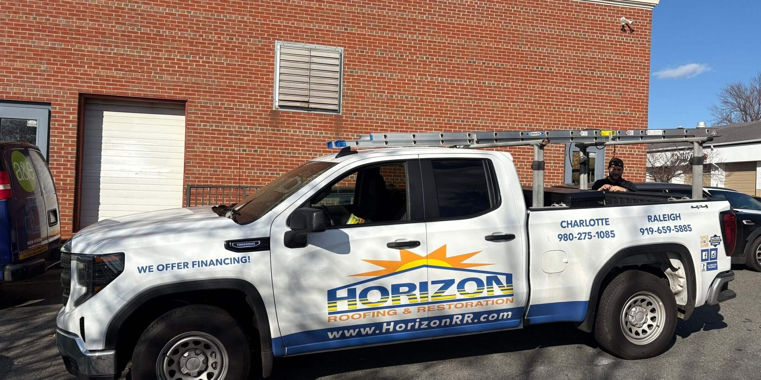 Horizon roofing truck parked outside a commercial roofing project location