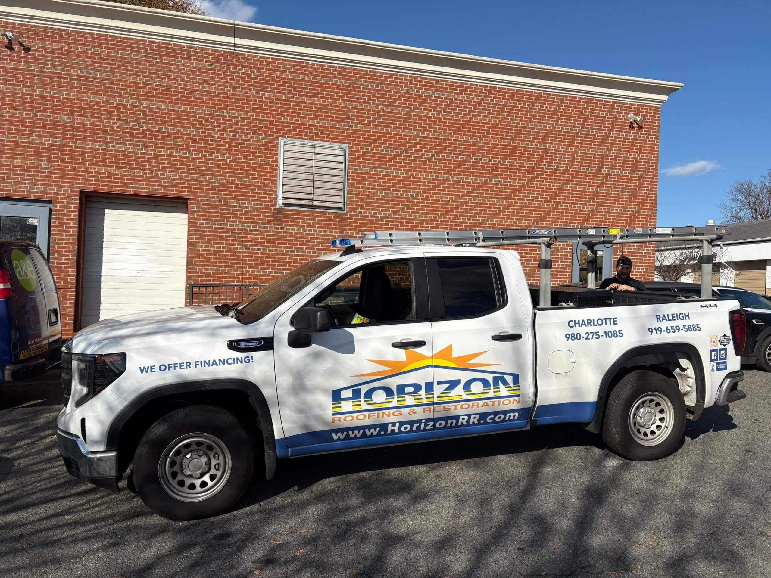Horizon roofing truck parked outside a commercial roofing project location