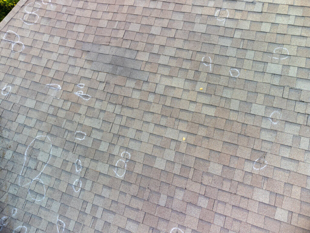 a roof marked to show storm damage found during a roof inspection